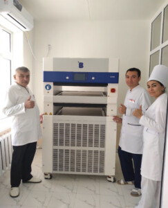 Navoi Region Blood Transfusion Station staff posing with a blood plasma Contact-Shock Freezer (CSF61) from B Medical Systems.